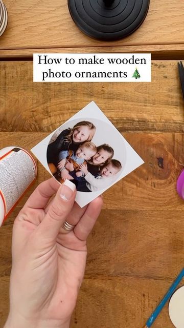 a person holding up a photo with the words how to make wooden photo ornaments