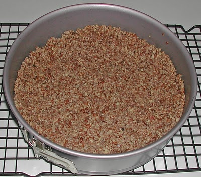 a metal pan filled with food sitting on top of a stove next to a wire rack