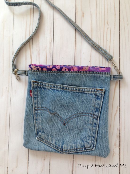 an old pair of jeans has been transformed into a cross - body bag with a zippered pocket