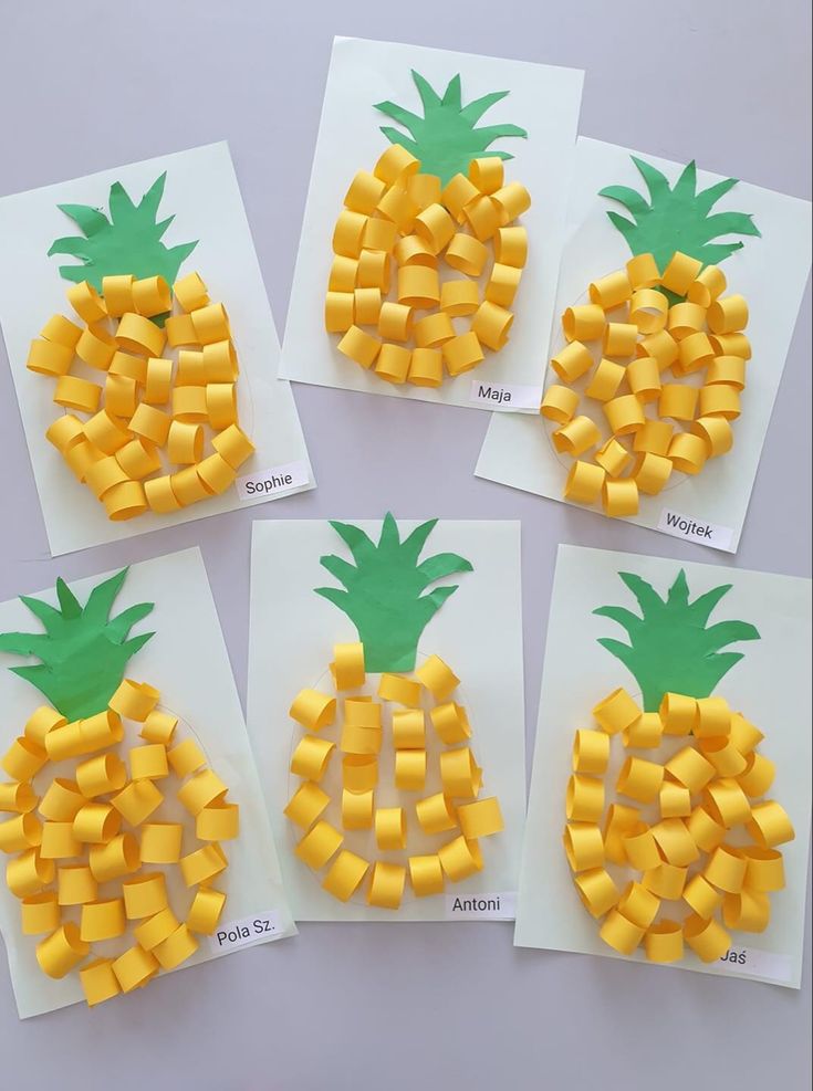 four pieces of paper cut to look like pineapples