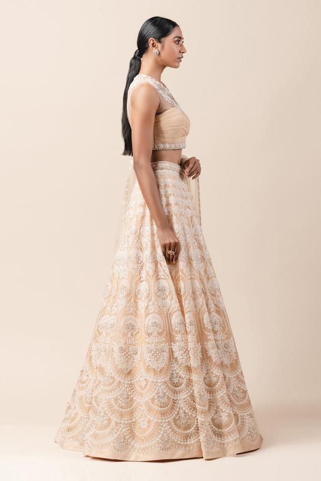 Peach lehenga with aari threadwork and highlighted with pearls-sequin. Comes with fluted blouse enhanced with French knots-pearl work and embroidered dupatta. Bollywood Beige Lehenga With Cutdana, Beige Cutdana Choli For Wedding, Beige Wedding Choli With Cutdana, Wedding Beige Choli With Cutdana, Elegant Chikankari Embroidery Choli For Reception, Elegant Chikankari Choli For Reception, Bollywood Style Beige Lehenga With Cutdana, Bollywood Style Beige Lehenga With Pallu, Traditional Drape Lehenga With Chikankari Embroidery For Reception