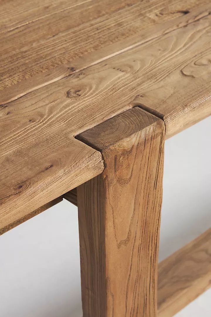 a close up of a wooden bench with no one around the table or in front of it