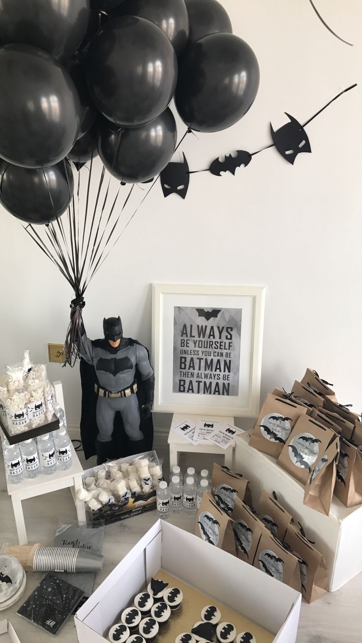 a batman themed birthday party with black balloons