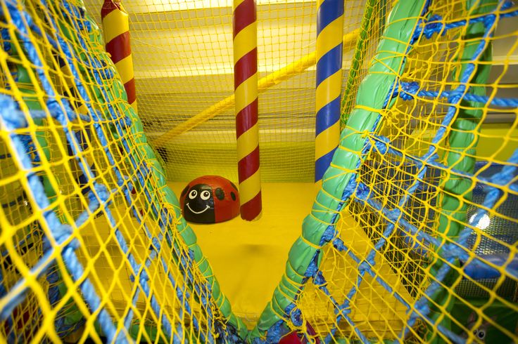 an inflatable ball pit with a ladybug on the front and yellow walls