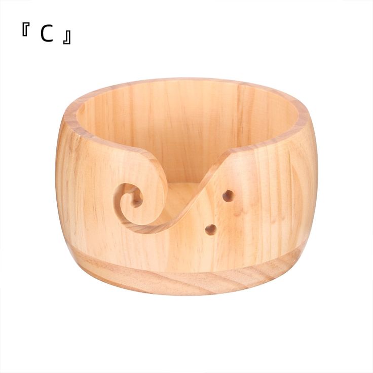 a wooden bowl with two holes in it