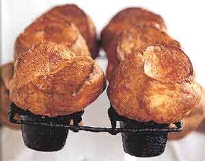 two pieces of bread sitting on top of each other in front of a person's hand