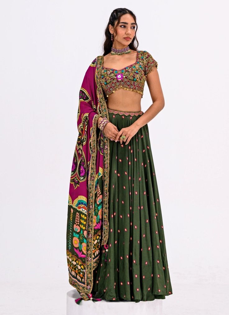 Elevate your ethnic wardrobe with this Green Embroidered Lehenga Set, a perfect blend of tradition and contemporary elegance. Crafted from luxurious crepe fabric, the flowy green lehenga is adorned with delicate pink polka dots, adding a subtle yet charming appeal. Paired with a stunning hand-embroidered blouse featuring intricate detailing and vibrant threadwork. The look is completed with a contrasting rani pink dupatta, designed with bold motifs and a rich color palette that beautifully enhan Green Pre-draped Saree With Intricate Embroidery For Festivals, Green Silk Anarkali Set For Reception, Green Floor-length Pre-draped Saree With Resham Embroidery, Floor-length Green Silk Choli, Green Georgette Sharara For Navratri, Green Georgette Navratri Sets, Green Georgette Sets For Navratri, Green Georgette Traditional Wear For Reception, Green Pre-draped Saree With Intricate Embroidery For Eid