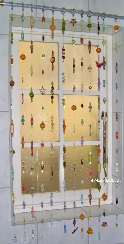 a window with glass beads hanging from it's sides