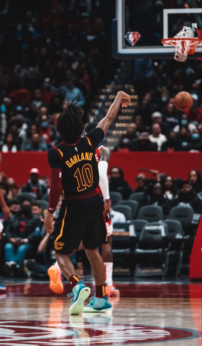 the basketball player is getting ready to dunk the ball