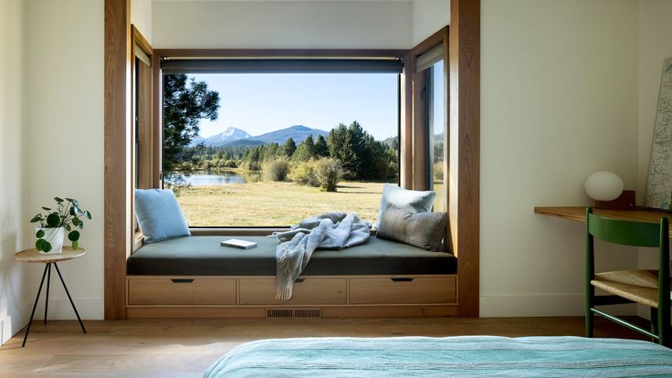 a bedroom with a large window seat next to a bed