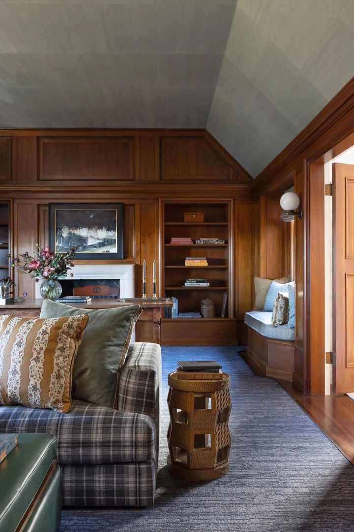 a living room with wood paneling and furniture in it's centerpieces