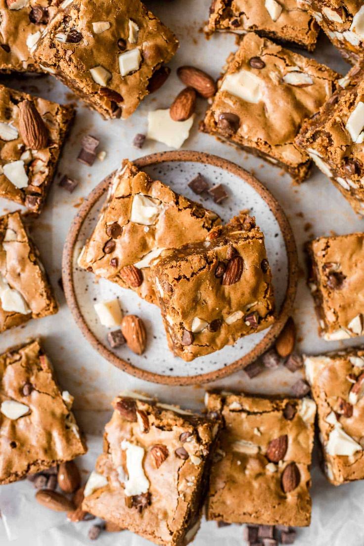 a white plate topped with brownies and nuts