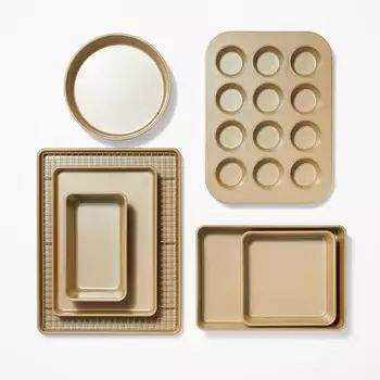 an assortment of cookie pans and trays on a white surface with one empty