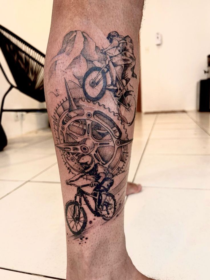 a man with a bike tattoo on his leg