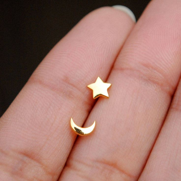 Tiny little stars and moons for everyday delights! Handcrafted in 14K gold, these trinkets can be worn as nose pins as well as ear studs. * Gold - 14K Solid Yellow Gold (star/moon + pushback) * Post length : 8 mm (approx.) * Dimensions (approximate) : 5-6 mm * Style : Pushback ------------- > Star Moon C/L Wire Nose Pins : https://www.etsy.com/in-en/listing/534464641/star-moon-14k-solid-gold-nose-pins-moon?ref=shop_home_active_1 Find us on Instagram for exquisite designs: @abhikajewels Like u Minimalist Gold Cartilage Earrings With Moon Charm, Gold Minimalist Cartilage Earrings With Moon Charm, Gold Moon Cartilage Earrings, Dainty Gold Crescent Cartilage Earrings, Gold Cartilage Earrings With Moon Charm, Gold Cartilage Earrings With Moon Charm For Gift, Celestial Star Cartilage Earrings As Gift, Dainty Crescent Cartilage Earrings As Gift, Celestial Star Piercings Gift