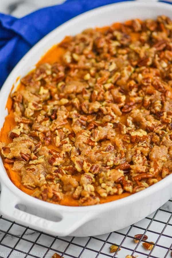 a white casserole dish filled with sweet potato casserole