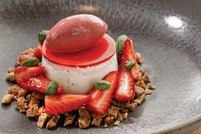 a dessert with strawberries and cream in a bowl