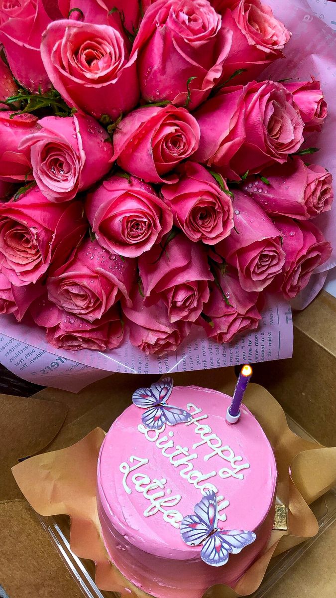 a bouquet of pink roses and a birthday cake