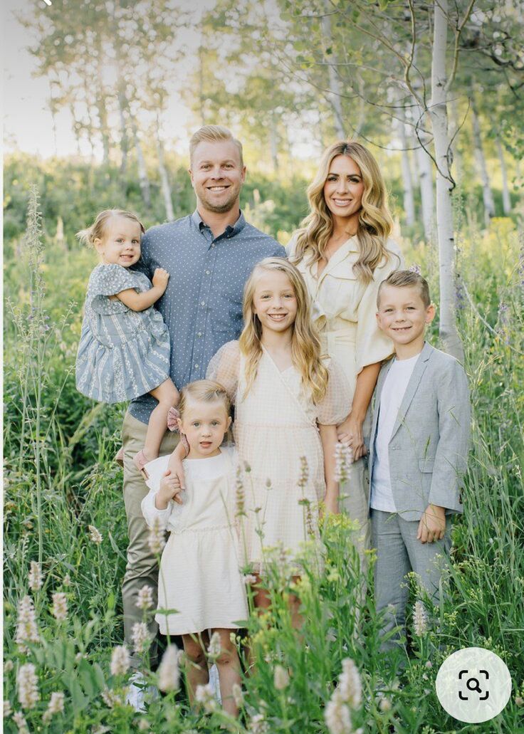 a family posing for a photo in the woods