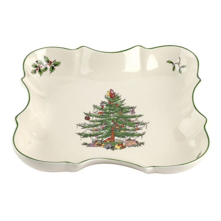 a white platter with a green trimming and a christmas tree on the side