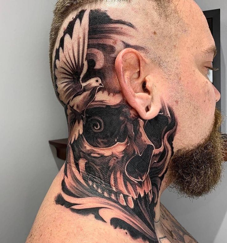 a man with a skull and bird tattoo on his neck