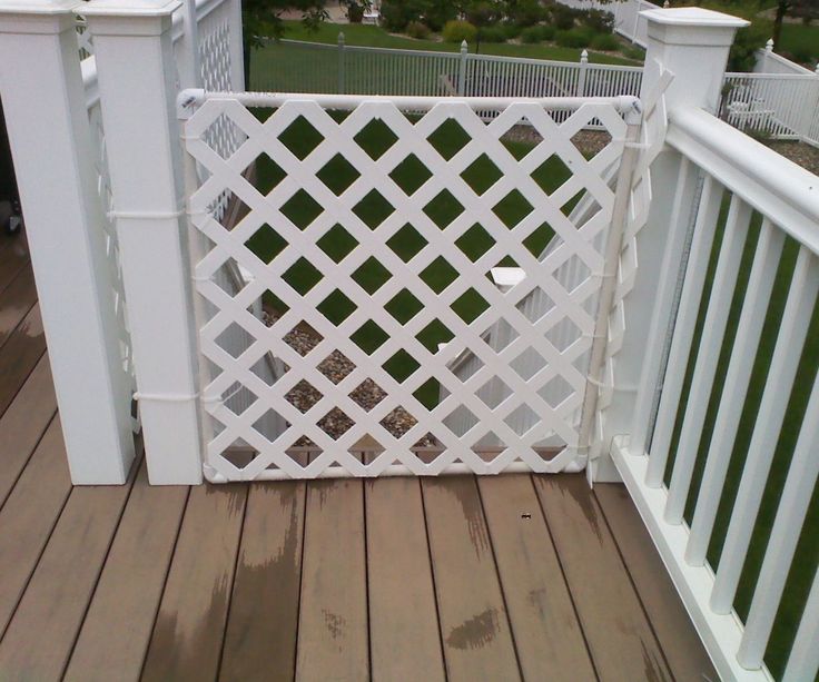 a white fence on top of a wooden deck