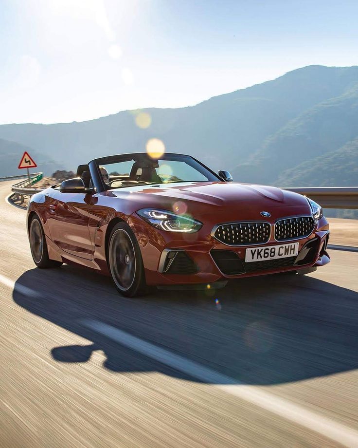 the bmw z4 roadster is driving on a road