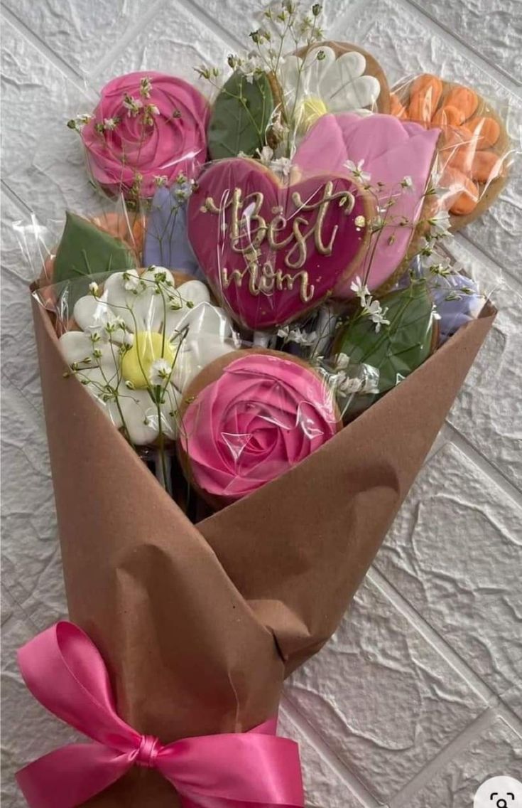 a bouquet of flowers wrapped in brown paper