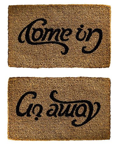 two door mats with the words come in and go out on them, one is black