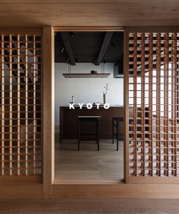 an open room with wooden slats on the wall and a table in the middle