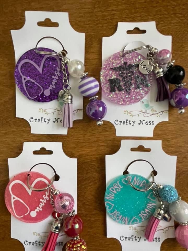 three different key chains with charms attached to them