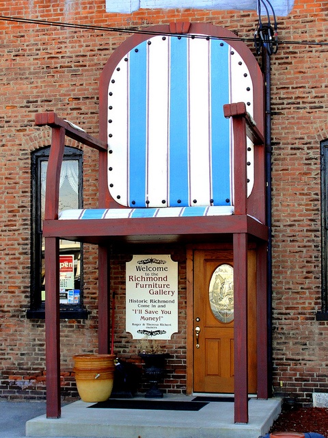 a building with a large blue and white chair on it's front