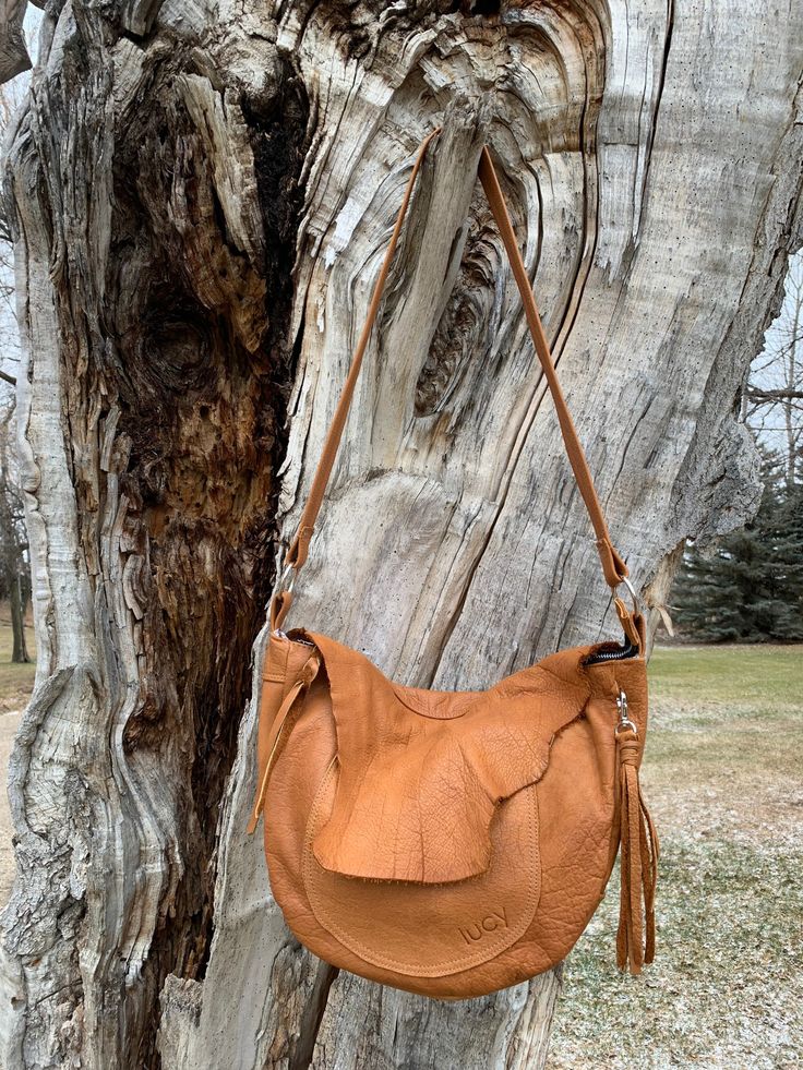 "This is the perfect bag to carry all of your must haves.  Front flap is playing solo, as it's natural details are enough.  Front pocket under the flap, back outside zipper pocket, and 4 pockets inside. Who knew floral and vintage clocks linings, work so great together.  The strap is long shoulder or short crossbody, but not adjustable.  This bag measures  14\"w at widest x 11 1/2\" h x 3\" all around" Everyday Saddle Flap Bag With Adjustable Strap, Leather Saddle Flap Bag For Everyday Use, Everyday Use Saddle Flap Bag With Adjustable Strap, Saddle Satchel With Detachable Strap, Everyday Saddle Flap Bag With Detachable Strap, Everyday Saddle Satchel With Removable Pouch, Saddle Flap Bag With Detachable Strap For Everyday Use, Everyday Saddle Satchel With Detachable Strap, Soft Leather Saddle Bag For Everyday Use