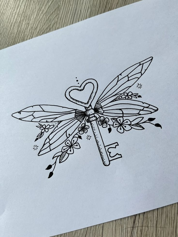 a drawing of a dragonfly with hearts and arrows on it's wings, sitting on top of a piece of paper