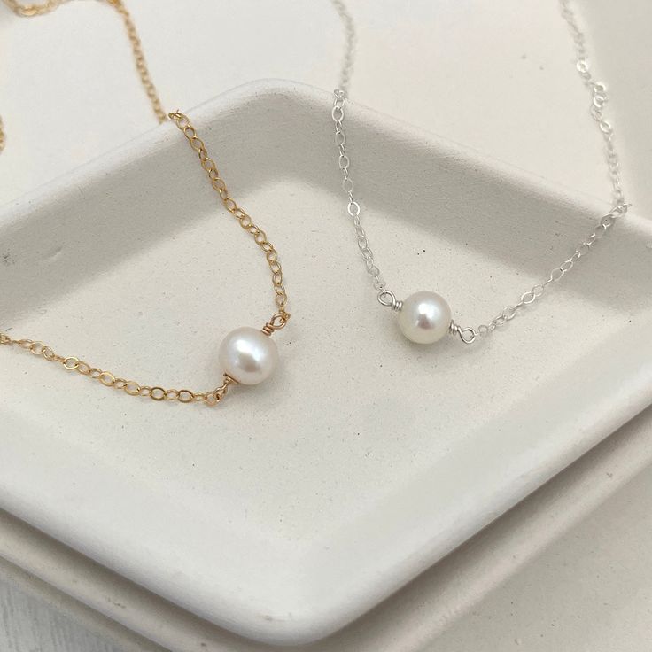 Simple, sophisticated, timeless. The Single Pearl Choker Necklace is a must-have in any jewelry lover's collection. Handmade in our studio of 14kt gold fill or sterling silver for long-term, worry-free wear, and freshwater 5mm pearls. For a perfect fit, use a string to measure where you would like your choker to hang on your neck and measure that against a ruler or tape measure. Elegant Everyday Nickel Free Necklace, Elegant Everyday Nickel-free Necklace, Dainty Everyday Pearl Charm Jewelry, Classic White Jewelry With Delicate Chain, Classic Everyday Nickel-free Necklaces, Classic White 14k Gold Filled Jewelry, Adjustable Everyday Pearl Chain Jewelry, 14k Gold-filled Silver Jewelry With Pearl Charm, Silver 14k Gold-filled Jewelry With Pearl Charm