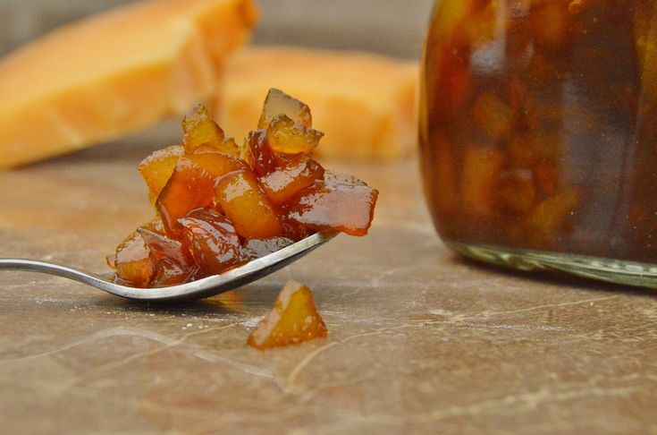 a spoon full of jelly sitting on top of a table