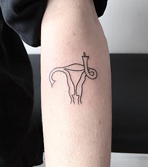 a person with a tattoo on their arm that has an image of a giraffe