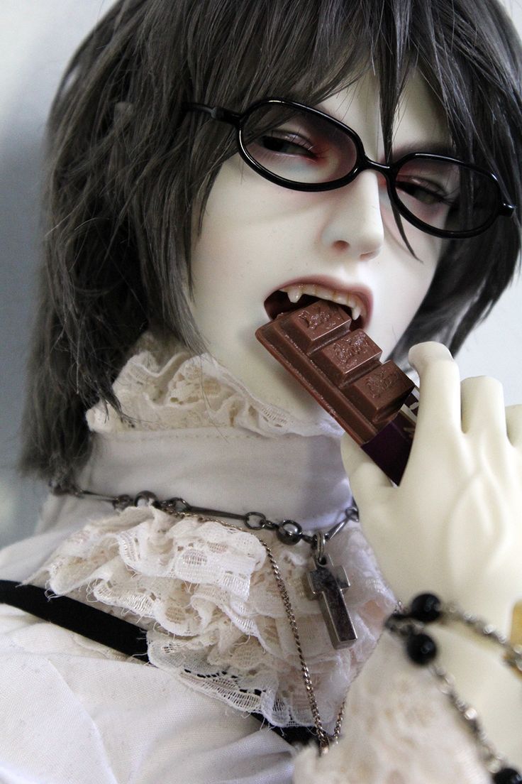 a mannequin holding a chocolate bar in her mouth