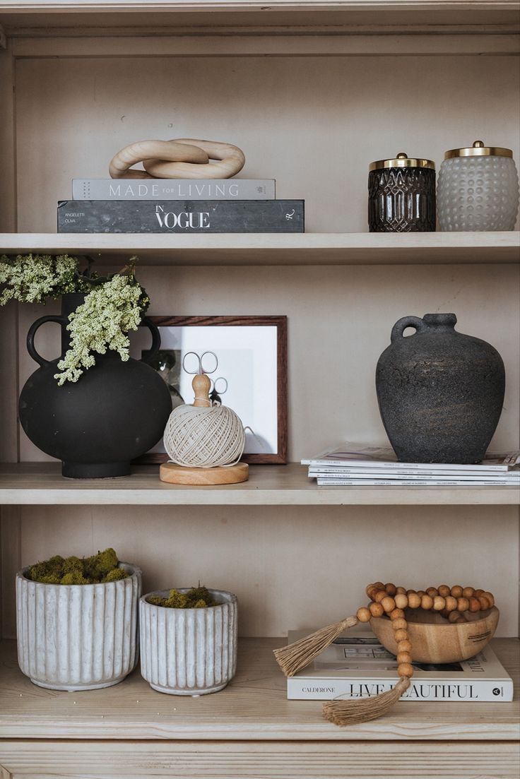 shelves with vases, books and other items on them