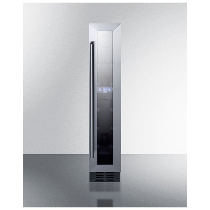 a tall stainless steel refrigerator sitting on top of a shiny countertop in front of a white wall