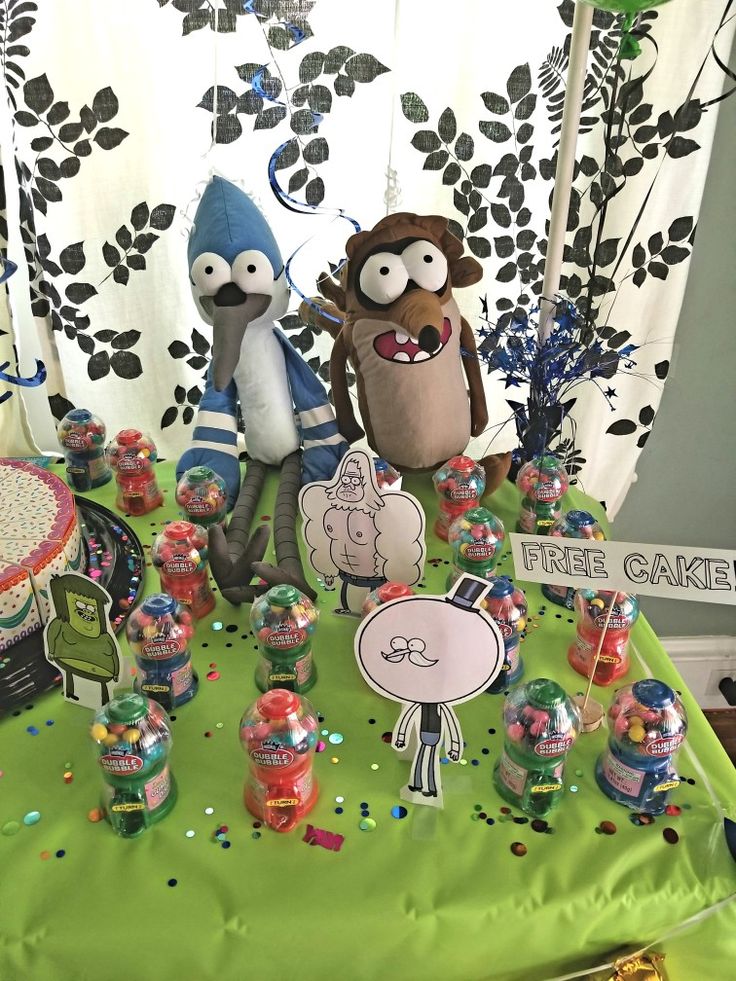 a table topped with cake and stuffed animals