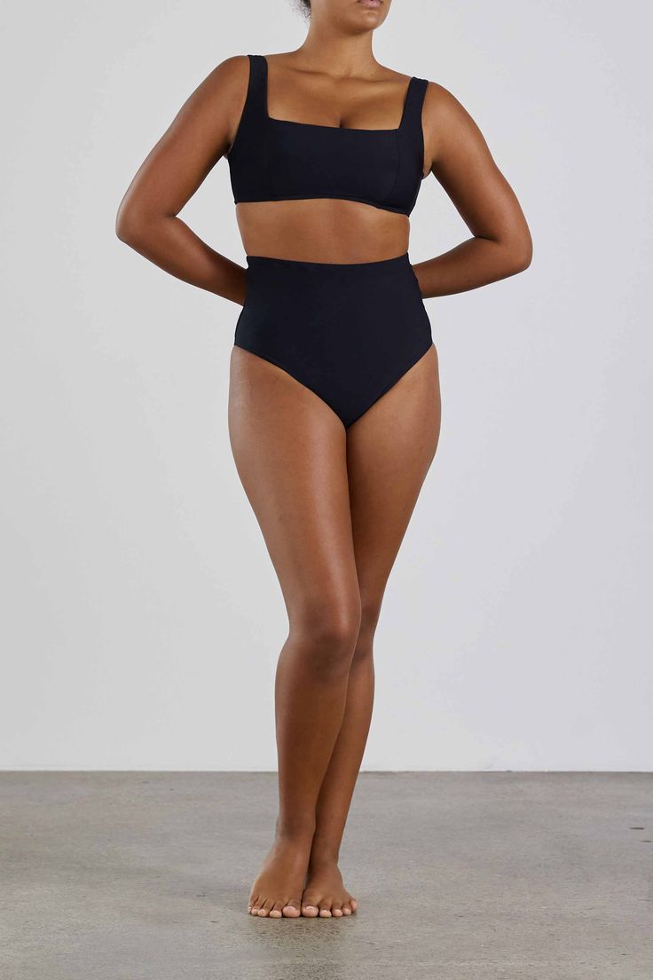 The Lola Bikini Top in Black is chic and understated. Designed to flatter and support the bust it is made using our technically advanced Sculpteur® fabric. With a minimal, square neckline and comfortable wide shoulder straps to provide extra support for larger busts, the top features panels and removable bra cups to enhance and define the bust's profile. Part of our Signature Collection, Lola is supremely comfortable, elegant and flattering for the ultimate in body confidence. Perfect for cup si Modern Second-skin Solid Swimwear, Modern Solid Swimwear With Seamless Construction, Fitted Seamless Swimwear Brief, Modern Solid Color Swimwear With Seamless Construction, Modern Seamless Swimwear, Modern Solid Color Seamless Swimwear, Black Shapewear Swimwear With Minimal Stretch, Seamless Bandeau Shapewear Swimwear, Minimal Stretch Black Shapewear Swimwear