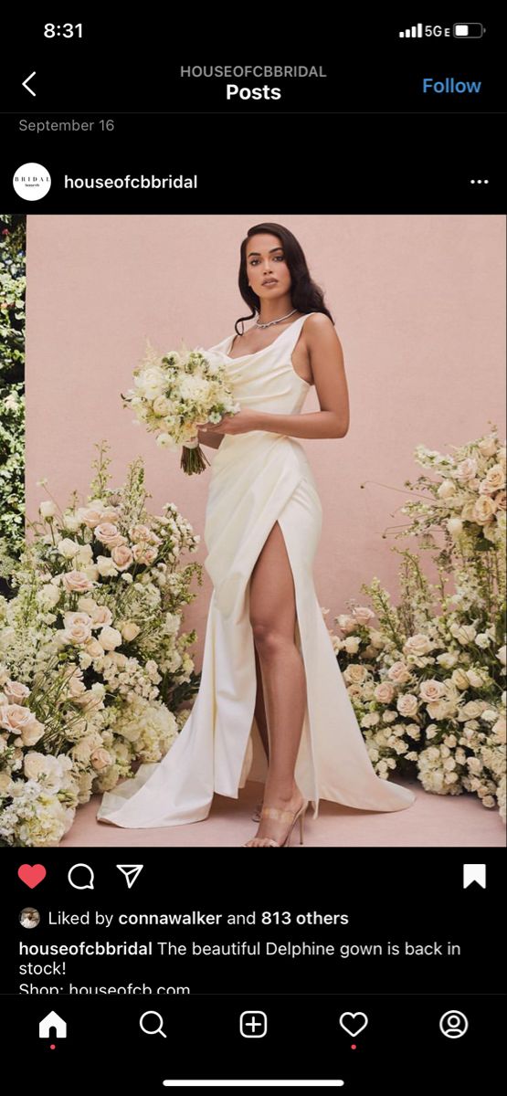 a woman in a white dress holding flowers and posing for a photo on her instagram page