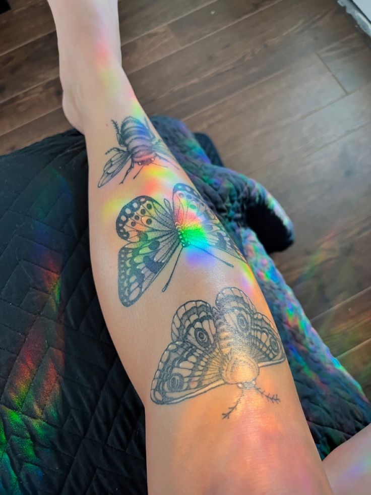 a woman's legs with tattoos and butterflies on them