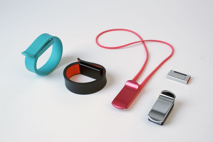 an assortment of electronic gadgets are displayed on a white surface, including a wristband