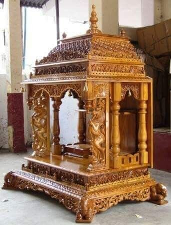 an ornate wooden structure in the middle of a room