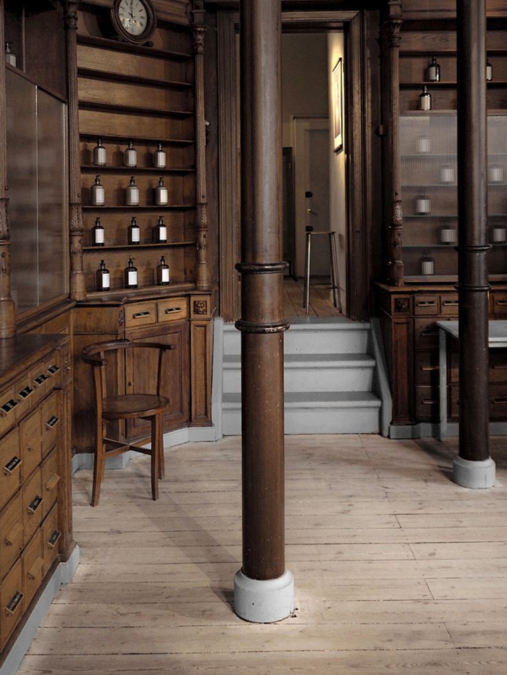 a room with wooden floors and tall columns