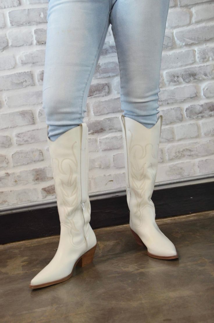 Introducing the “Tall White Boots” – a bold and stylish take on classic cowgirl boots. These striking white boots feature a tall silhouette that adds a touch of modern flair to traditional Western design. Crafted for both comfort and durability, they offer a chic and versatile option for a variety of outfits. Whether you’re dressing up or keeping it casual, the “Tall White Boots” make a statement with their unique color and timeless style. Elevate your footwear collection with these eye-catching cowgirl boots. White Heeled Boots For Fall Rodeo, White Heeled Boots For Rodeo In Fall, Chic Ranch Boots For Spring, Chic Spring Boots For Ranch, Chic Spring Ranch Boots, White Boots For Ranch In Fall, Western White Boots With Stacked Heel, Spring Wide Calf Knee-high Boots For Ranch, White Mid-calf Boots With Stacked Heel For Fall