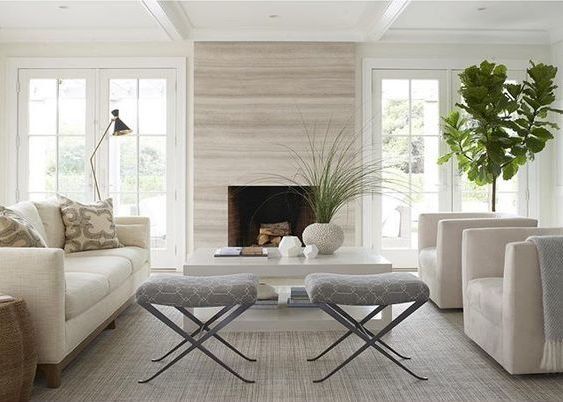 a living room filled with furniture and a fire place in the middle of a room