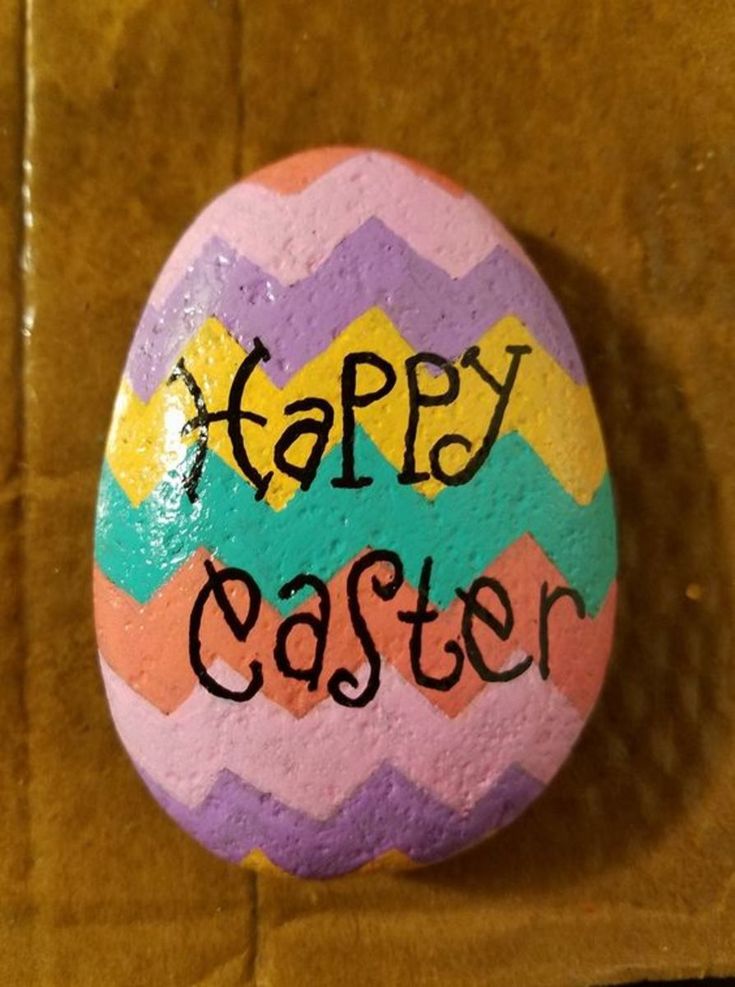 a painted rock with the words happy easter on it